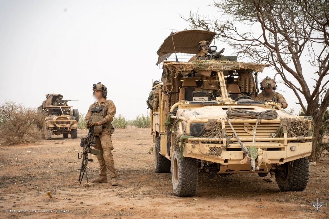 Military vehicles and personnel in Mali with Black Snake on the hood of vehicle 